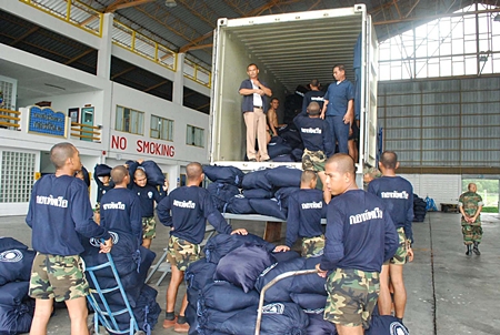 Sailors load up the containers for their long trip north.